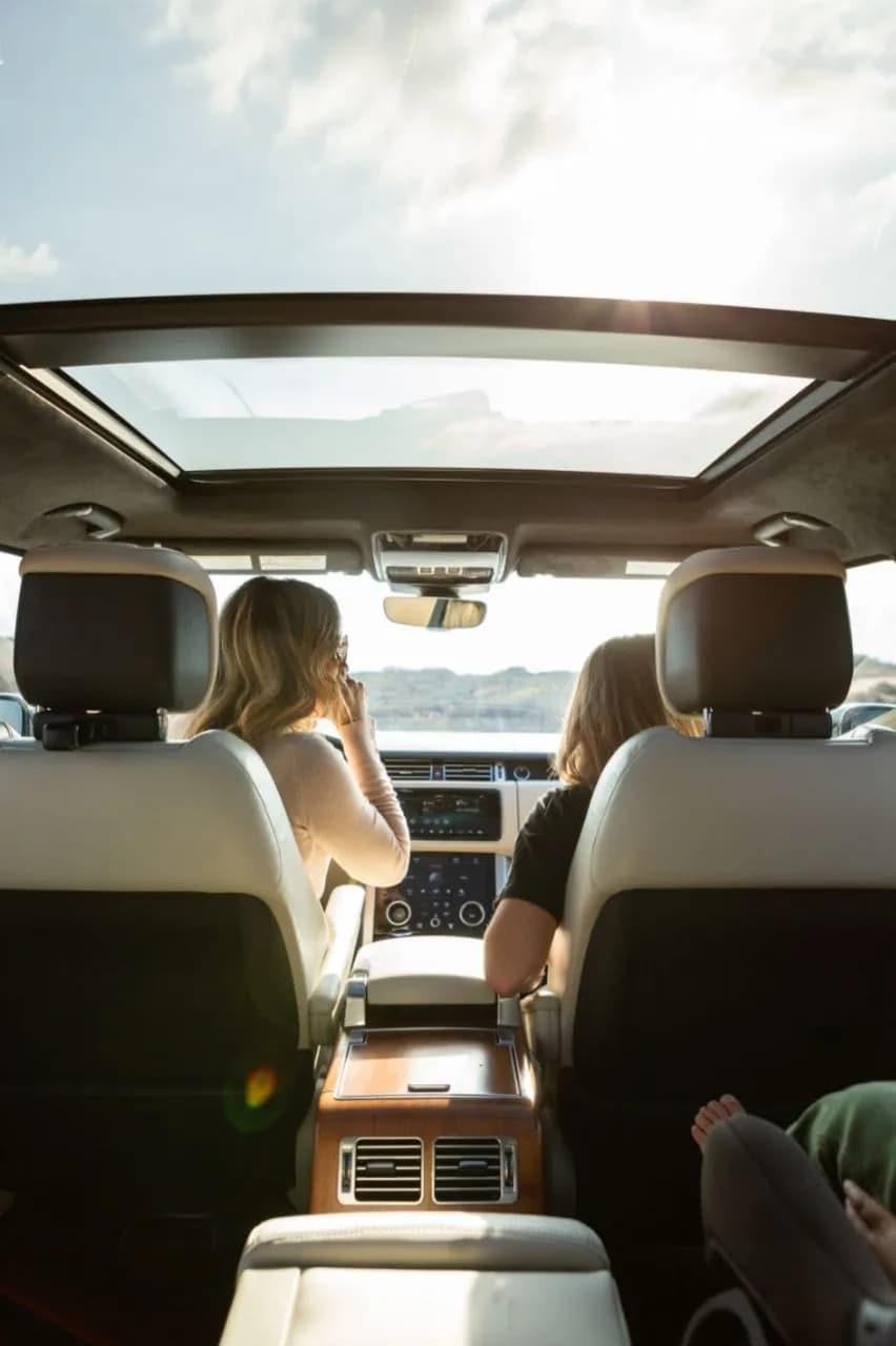 Sunlight pouring through a panoramic roof into a car cabin
